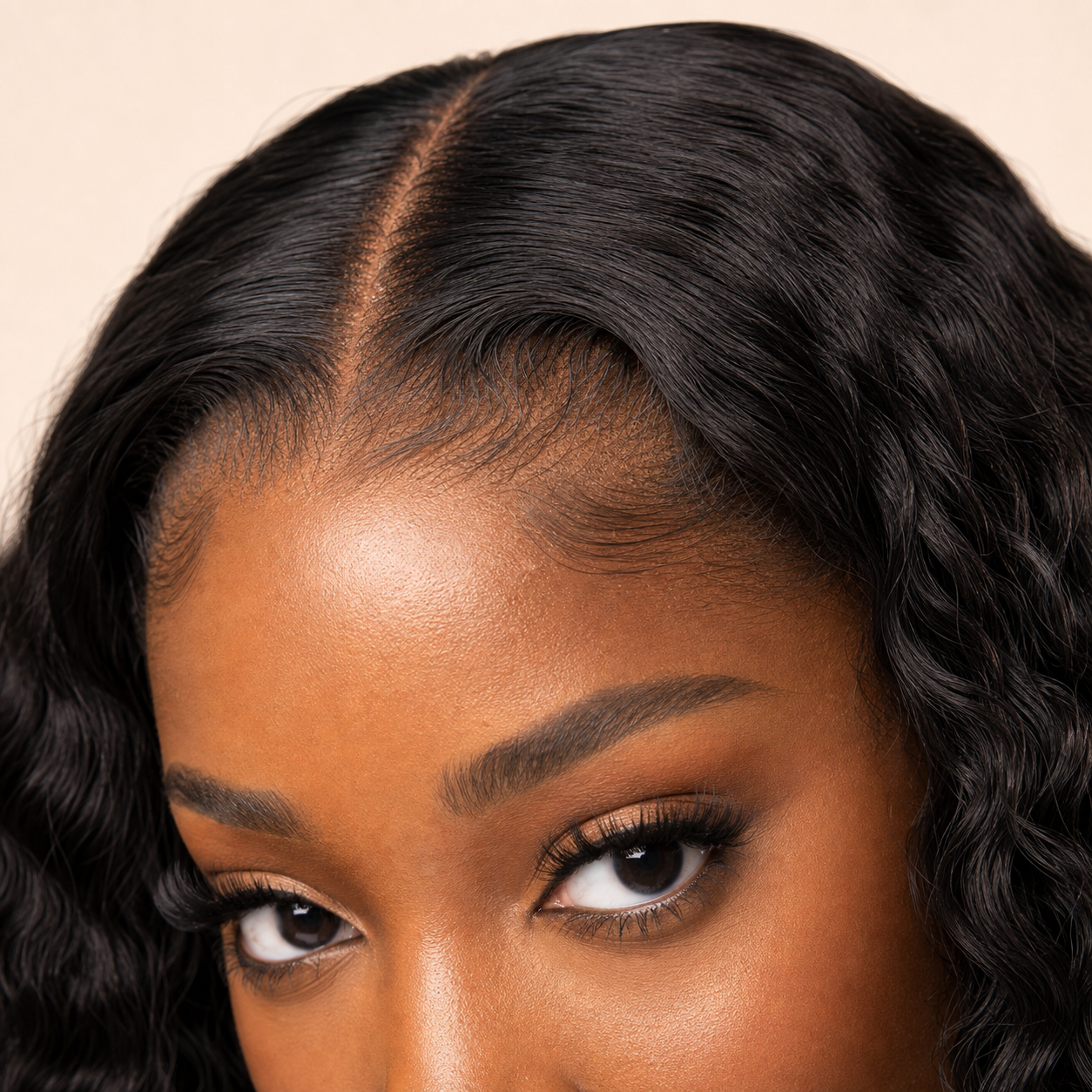 Close-up of melting HD lace and pre-plucked natural hairline on deep brown skin