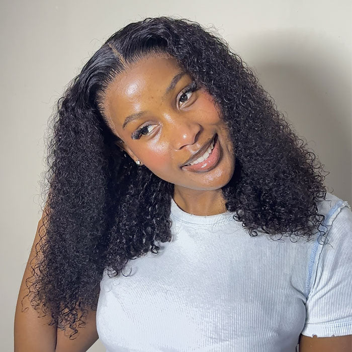 Natural-black curly bob on a model, with the hair swept back to show the styled hairline.