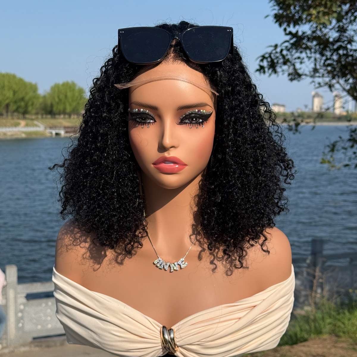 Curly bob displayed on a mannequin outdoors, viewed from the front.